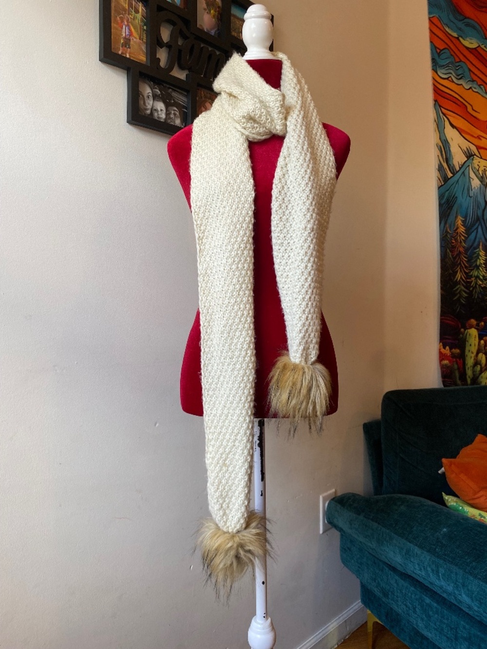 white knitted scarf featuring pom poms